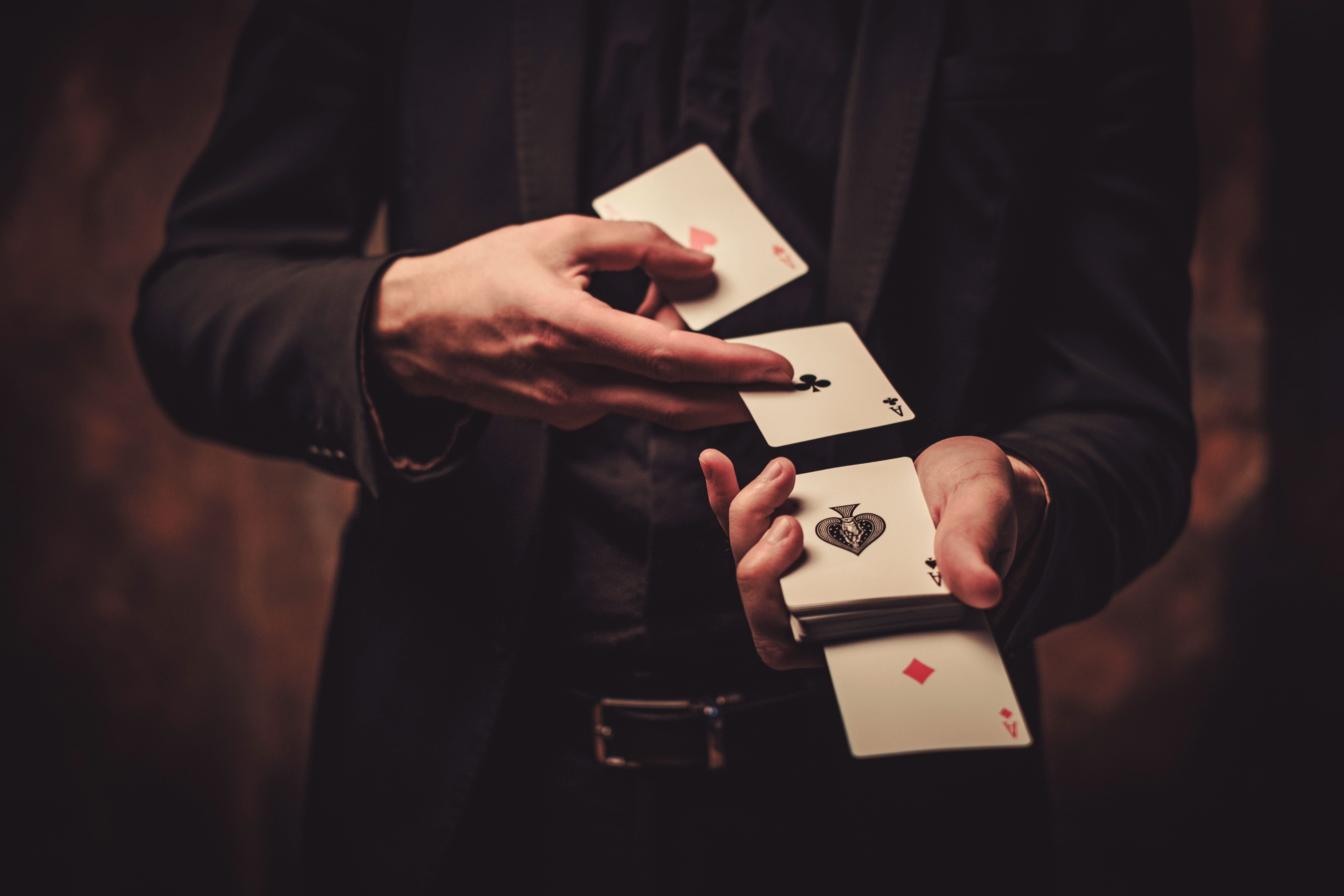 A Janeda Magician entertaining a group of corporate guests in suits during a performance